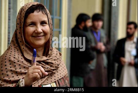 An Afghan woman shows her inked finger after casting her ballot at a polling center in Kabul, Afghanistan, on April 5, 2014. The polling for Afghanistan s presidential election concluded on Saturday and counting of ballots has begun, the country s election officials said. A total of 6,218 polling centers remained open on the election day and around 7 million eligible voters, 36 percent of them women, had cast their votes. (Xinhua/Maryam Khamosh) AFGHANISTAN-PRESIDENTIAL ELECTION-BALLOTING-CONCLUSION PUBLICATIONxNOTxINxCHN   to Afghan Woman Shows her inked Fingers After Casting her Ballot AT a Stock Photo