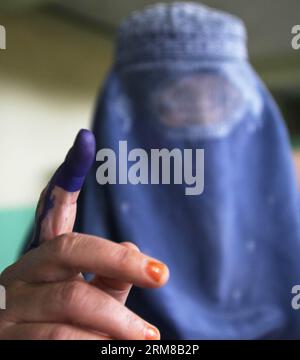 An Afghan woman shows her inked finger after casting her ballot at a polling center in Kabul, Afghanistan, on April 5, 2014. The polling for Afghanistan s presidential election concluded on Saturday and counting of ballots has begun, the country s election officials said. A total of 6,218 polling centers remained open on the election day and around 7 million eligible voters, 36 percent of them women, had cast their votes. (Xinhua/Ahmad Massoud) AFGHANISTAN-PRESIDENTIAL ELECTION-BALLOTING-CONCLUSION PUBLICATIONxNOTxINxCHN   to Afghan Woman Shows her inked Fingers After Casting her Ballot AT a P Stock Photo