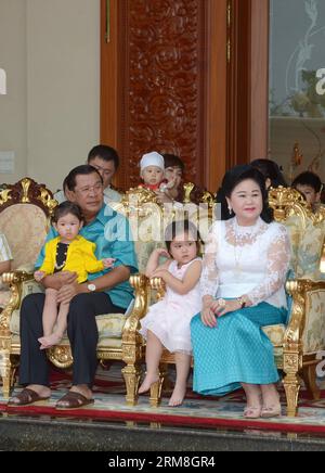 Cambodian Prime Minister Hun Sen (L) and his wife Bun Rany (R) sit with their grandchildren during the Khmer New Year celebration at their residence in Phnom Penh, Cambodia, April 14, 2014. Cambodia on Monday organized an elaborate ceremony in front of the centerpiece of Angkor Wat temple, a World Heritage Site, in Siem Reap province to greet the Sangkranta festival or Khmer New Year. (Xinhua/Sovannara) CAMBODIA-PHNOM PENH-KHMER NEW YEAR-CEREMONY PUBLICATIONxNOTxINxCHN   Cambodian Prime Ministers HUN Sen l and His wife Bun Rany r Sit With their grand children during The Khmer New Year Celebrat Stock Photo