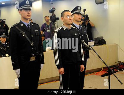 (140417) -- BEIJING, April 17, 2014 (Xinhua) -- Qin Zhijun (C front), an alleged rumormonger, goes on trial at the Chaoyang District People s Court in Beijing, capital of China, April 17, 2014. Qin Zhihui, known as Qinhuohuo in cyberspace, was accused of creating and spreading rumors about several Chinese celebrities including popular TV hostess Yang Lan, as well as China s former Ministry of Railways, via Sina Weibo, China s Twitter-like service, from December 2012 to August 2013, according to prosecutors. Qin was sentenced to two years on defamation charges and another year for affray on Thu Stock Photo