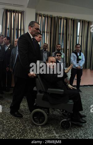 (140417) -- ALGIERS, April 17, 2014 (Xinhua) -- Algerian President Abdelaziz Bouteflika (front R) arrives at a polling center to cast his ballot in El Biar, suburb of Algiers, Algeria, on April 17, 2014. Algerian voters started casting ballots Thursday morning in the country s presidential election, which pits incumbent President Abdelaziz Bouteflika against former Prime Minister Ali Benflis and four other candidates. (Xinhua/Mohamed Kadri) ALGERIA-ALGIERS-ELECTION-VOTE-BOUTEFLIKA PUBLICATIONxNOTxINxCHN   Algiers April 17 2014 XINHUA Algerian President Abdel Aziz Bouteflika Front r arrives AT Stock Photo