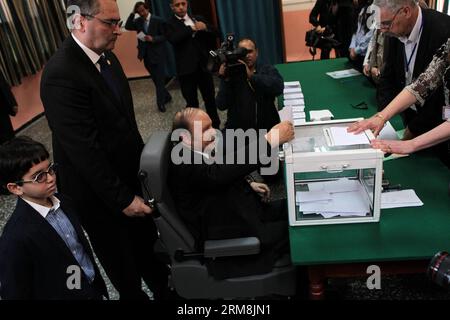 (140417) -- ALGIERS, April 17, 2014 (Xinhua) -- Algerian President Abdelaziz Bouteflika (C) casts his ballot at a polling center in El Biar, suburb of Algiers, Algeria, on April 17, 2014. Algerian voters started casting ballots Thursday morning in the country s presidential election, which pits incumbent President Abdelaziz Bouteflika against former Prime Minister Ali Benflis and four other candidates. (Xinhua/Mohamed Kadri) ALGERIA-ALGIERS-ELECTION-VOTE-BOUTEFLIKA PUBLICATIONxNOTxINxCHN   Algiers April 17 2014 XINHUA Algerian President Abdel Aziz Bouteflika C casts His Ballot AT a Polling Cen Stock Photo