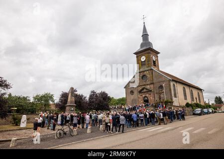 Pexonne, France. 27th Aug, 2023. People stand in front of the village church during a memorial ceremony for the invasion of Pexonne on August 27, 1944. German soldiers invaded the French village of Pexonne in late August 1944 and kidnapped dozens of villagers. The action was led by SS-Hauptsturmführer Erich Otto Wenger. Now Wenger's grandchildren came to the town for the first time to take part in a memorial service for the victims of the crime. Credit: Philipp von Ditfurth/dpa/Alamy Live News Stock Photo
