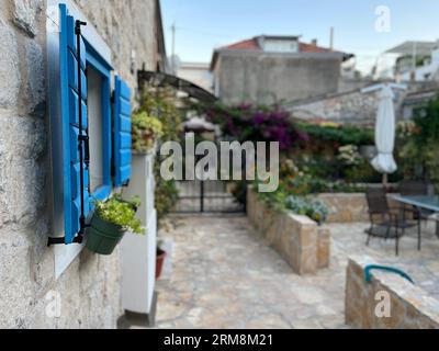 Beautiful bright blue window shutters on a beautifully preserved old house in a hillside suburb of Split, Croatia Stock Photo