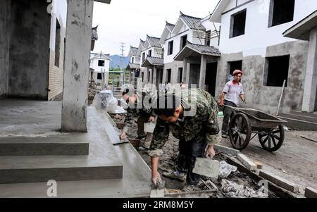 (140419) -- YA AN, April 19, 2014 (Xinhua) -- People work at the construction site of cottages at Longquan Village in Ya an City, southwest China s Sichuan province, April 19, 2014. Ya an, where 196 people were killed, and over 11,000 injured in a 7.0 magnitude earthquake last year, has finished most of the housing reconstruction work by April 5. (Xinhua/Jiang Hongjing) (wf) CHINA-SICHUAN-YA AN-EARTHUAKE-RECONSTRUCTION (CN) PUBLICATIONxNOTxINxCHN   Ya to April 19 2014 XINHUA Celebrities Work AT The Construction Site of Cottages AT Longquan Village in Ya to City Southwest China S Sichuan Provin Stock Photo