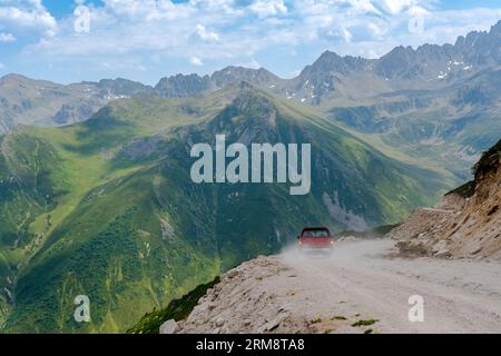 A red pickup truck driving on dirt roads on high plateau roads in Turkey Stock Photo