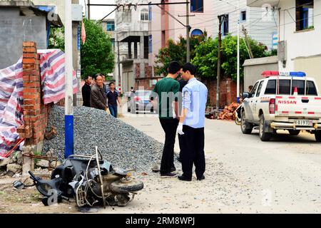 (140428) -- MINHOU, April 28, 2014 (Xinhua) -- Police inspect the scene of a car incident in Minhou County, Fuzhou, southeast China s Fujian Province, April 28, 2014. Six people were killed when a car hit a group of pedestrians in Fuzhou on Monday, local police said. And 13 others were injured. The victims were mostly from a nearby primary school and family members who had come to pick them up for lunch. The vehicle plowed into crowd before colliding with other cars for some two kilometers, before finally being stopped by police. The driver stayed inside the Lexus, threatening to ignite petrol Stock Photo