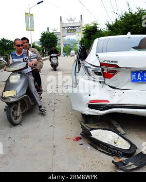 (140428) -- MINHOU, April 28, 2014 (Xinhua) -- People view the scene of a car incident in Minhou County, Fuzhou, southeast China s Fujian Province, April 28, 2014. Six people were killed when a car hit a group of pedestrians in Fuzhou on Monday, local police said. And 13 others were injured. The victims were mostly from a nearby primary school and family members who had come to pick them up for lunch. The vehicle plowed into crowd before colliding with other cars for some two kilometers, before finally being stopped by police. The driver stayed inside the Lexus, threatening to ignite petrol th Stock Photo