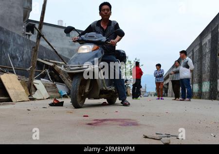 (140428) -- MINHOU, April 28, 2014 (Xinhua) -- Blood is seen at the scene of a car incident in Minhou County, Fuzhou, southeast China s Fujian Province, April 28, 2014. Six people were killed when a car hit a group of pedestrians in Fuzhou on Monday, local police said. And 13 others were injured. The victims were mostly from a nearby primary school and family members who had come to pick them up for lunch. The vehicle plowed into crowd before colliding with other cars for some two kilometers, before finally being stopped by police. The driver stayed inside the Lexus, threatening to ignite petr Stock Photo