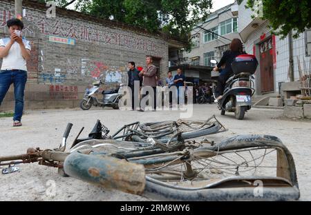 (140428) -- MINHOU, April 28, 2014 (Xinhua) -- A broken bike is seen at the scene of a car incident in Minhou County, Fuzhou, southeast China s Fujian Province, April 28, 2014. Six people were killed when a car hit a group of pedestrians in Fuzhou on Monday, local police said. And 13 others were injured. The victims were mostly from a nearby primary school and family members who had come to pick them up for lunch. The vehicle plowed into crowd before colliding with other cars for some two kilometers, before finally being stopped by police. The driver stayed inside the Lexus, threatening to ign Stock Photo