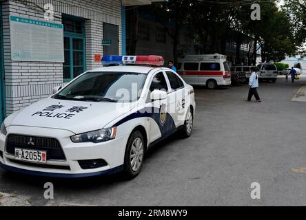 (140428) -- MINHOU, April 28, 2014 (Xinhua) -- A police car parks at the No. 2 People s Hospital of Minhou County, where injured pedestrians are treated, in Fuzhou, southeast China s Fujian Province, April 28, 2014. Six people were killed when a car hit a group of pedestrians in Fuzhou on Monday, local police said. And 13 others were injured. The victims were mostly from a nearby primary school and family members who had come to pick them up for lunch. The vehicle plowed into crowd before colliding with other cars for some two kilometers, before finally being stopped by police. The driver stay Stock Photo