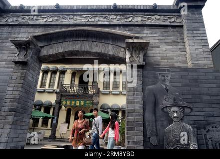 CHENGDU, April 29, 2014 (Xinhua) -- Tourists go sightseeing on the Kuan Zhai Xiang Zi, or the Wide and Narrow Alleys in Chengdu, capital of southwest China s Sichuan Province, April 29, 2014. Consisting of three remodeled historical community alleyways dating back to the Qing Dynasty, the Wide and Narrow Alleys are now bordered with exquisitely decorated tea houses, cafes, boutiques and bookstores. (Xinhua/Wang Song) (wf) CHINA-SICHUAN-CHENGDU-WIDE AND NARROW ALLEYS(CN) PUBLICATIONxNOTxINxCHN   Chengdu April 29 2014 XINHUA tourists Go Sightseeing ON The Kuan Zhai Xiang Ro or The Wide and Narro Stock Photo