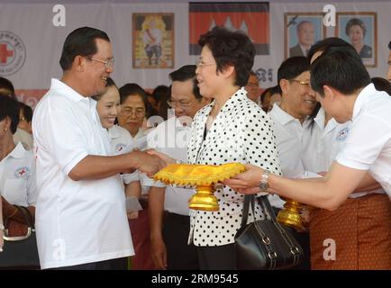 (140508) -- PHNOM PENH, May 8, 2014 (Xinhua) -- Chinese Ambassador to Cambodia Bu Jianguo (C, front) shakes hands with Cambodian Prime Minister Hun Sen (L, front) during a celebration of the 151st anniversary of the World Red Cross and Red Crescent Day in Phnom Penh, Cambodia, May 8, 2014. Cambodia on Thursday celebrated the 151st anniversary of the World Red Cross and Red Crescent Day, calling for more contributions from donors to support humanitarian activities. (Xinhua/Sovannara) CAMBODIA-PHNOM PENH-RED CROSS DAY PUBLICATIONxNOTxINxCHN   Phnom Penh May 8 2014 XINHUA Chinese Ambassador to Ca Stock Photo