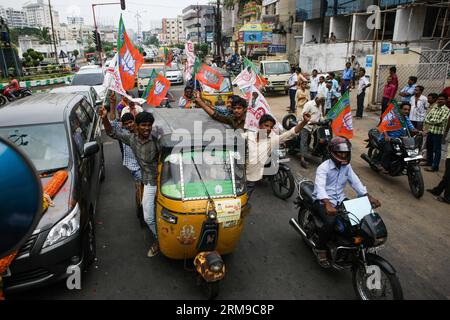 (140517) -- VISAKHAPATNAM, May 17, 2014 (Xinhua) -- Supporters of India s main opposition Bharatiya Janata Party (BJP) and its allies celebrate during a parade in Visakhapatnam of Andra Pradesh, India, May 17, 2014. BJP Friday created history by winning the general elections by a landslide, the most resounding victory by any party in the last 30 years, decimating the Nehru-Gandhi dynasty-led ruling Congress Party. (Xinhua/Zheng Huansong) INDIA-VISAKHAPATNAM-BJP-CELEBRATION PUBLICATIONxNOTxINxCHN   May 17 2014 XINHUA Supporters of India S Main Opposition Bharatiya Janata Party BJP and its  Cele Stock Photo