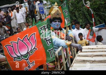 (140517) -- VISAKHAPATNAM, May 17, 2014 (Xinhua) -- A supporter of India s main opposition Bharatiya Janata Party (BJP) attends a parade in Visakhapatnam of Andra Pradesh, India, May 17, 2014. BJP Friday created history by winning the general elections by a landslide, the most resounding victory by any party in the last 30 years, decimating the Nehru-Gandhi dynasty-led ruling Congress Party. (Xinhua/Zheng Huansong) INDIA-VISAKHAPATNAM-BJP-CELEBRATION PUBLICATIONxNOTxINxCHN   May 17 2014 XINHUA a Supporter of India S Main Opposition Bharatiya Janata Party BJP Attends a Parade in  of Andra Prade Stock Photo