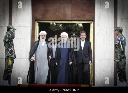 (140520) -- TEHRAN, May 20, 2014 (Xinhua) -- Iranian President Hassan Rouhani (C) smiles before leaving for China at Mehrabad Airport in Tehran, Iran, on May 20, 2014. Rouhani left Tehran for Shanghai on Tuesday morning to attend the Conference on Interaction and Confidence Building Measures in Asia (CICA) summit, to be held in Shanghai on May 20-21. (Xinhua/Ahmad Halabisaz) (zjy) FOCUS IRAN-CHINA-ROUHANI-CICA SUMMIT PUBLICATIONxNOTxINxCHN   TEHRAN May 20 2014 XINHUA Iranian President Hassan Rouhani C Smiles Before leaving for China AT Mehrabad Airport in TEHRAN Iran ON May 20 2014 Rouhani lef Stock Photo