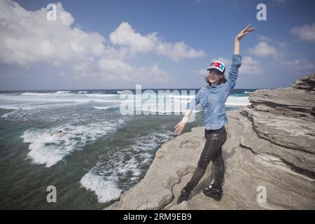 (140520) -- BEIJING, May 20, 2014 (Xinhua) -- Sun Xiaoqian, a 24-year-old ballerina of the National Ballet of China, poses at seaside during their tour on Yongxing Island of Sansha, south China s Hainan Province, Jan. 11, 2014. Before being able to present perfect performance in the spotlight, every member of the National Ballet of China has to undergo severe arduous training for years. Yet they chose to persevere in what they truely love. Years of toiling not only allows them good body shape, expertise and disposition, but also offers them a life-long goal that deserves pursuing. The glory on Stock Photo