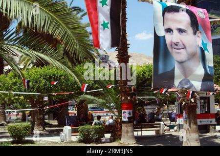 People walk under posters of Syria s presidential elections in Damascus, on May 25, 2014. Electoral campaigns in Syria started on May 11 and would end 24 hours ahead of the voting. (Xinhua/Bassem Tellawi) SYRIA-DAMASCUS-POLITICS-ELECTION PUBLICATIONxNOTxINxCHN   Celebrities Walk Under Posters of Syria S Presidential Elections in Damascus ON May 25 2014 Electoral Campaigns in Syria started ON May 11 and Would End 24 Hours Ahead of The Voting XINHUA Bassem  Syria Damascus POLITICS ELECTION PUBLICATIONxNOTxINxCHN Stock Photo