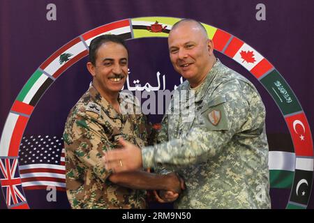 (140527) -- AMMAN, May 27, 2014 (Xinhua) -- U.S. Army Maj. Gen. Robert Catalanotti (R), the US Central Command director of exercises and training, shakes hands with Brigadier Fahad Faleh Al Damen, the Jordanian Director of Training Armed Forces, during a news conference regarding the annual multilateral training exercise Eager Lion in Amman, Jordan, May 27, 2014. The Jordan-hosted Eager Lion international military drill that started this week with the participation of 22 countries seeks to strengthen the skills of the Jordanian army and enhance cooperation, the Jordan Armed Forces said on Tues Stock Photo