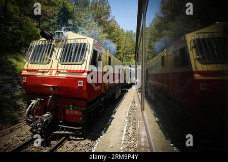 HIMACHAL PRADESH, May 28, 2013 (Xinhua) -- Trains are in operation on the Kalka-Shimla Railway in north India s Himachal Pradesh, May 28, 2014. The Kalka-Shimla Railway is a 762?mm narrow gauge railway in North-West India s Himachal Pradesh travelling along a mostly mountainous route from Kalka to Shimla. It is known for dramatic views of the hills and surrounding villages. The 96-km long railway was built since 1898 to provide a service to the highland town of Shimla. Three still fully operational railways, the Darjeeling Himalayan Railway in India s West Bengal, the Nilgiri Mountain Railway Stock Photo