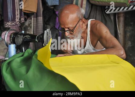 (140529) -- DHAKA, May 29, 2013 (Xinhua) -- A tailor sews a Brazilian national flag ahead of the upcoming 2014 FIFA World Cup in Dhaka, Bangladesh, May 29, 2014. The 2014 FIFA World Cup International Football tournament will kick off in Brazil on June 12, 2014. (Xinhua/Shariful Islam) (SP)BANGLADESH-DHAKA-2014 FIFA WORLD CUP-FOOTBALL-FLAGS PUBLICATIONxNOTxINxCHN   Dhaka May 29 2013 XINHUA a Tailor sews a Brazilian National Flag Ahead of The upcoming 2014 FIFA World Cup in Dhaka Bangladesh May 29 2014 The 2014 FIFA World Cup International Football Tournament will Kick off in Brazil ON June 12 2 Stock Photo