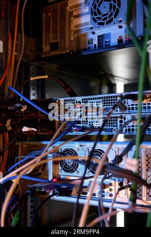 Closeup data wires and cables in dark server room Stock Photo
