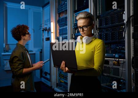 Serious technicians working together with network hardware Stock Photo