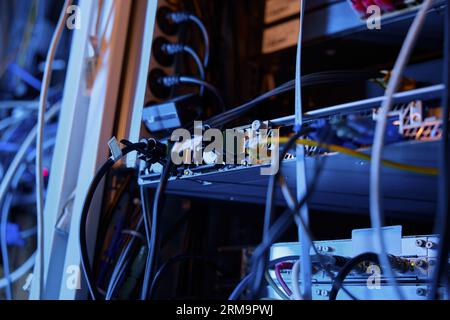 Closeup wires and cables in dark server room Stock Photo