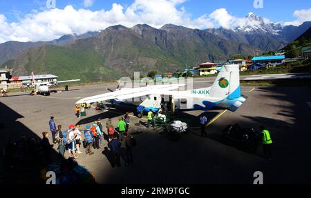 Tourists queue up to board a plane flying from Lukla to Kathmandu at Tenzing-Hillary airport, also known as Lukla airport, in Solukhumbu, Nepal, June 1, 2014. The airport is a small airport in the town of Lukla and rated as one of the most dangerous airport in the world.(Xinhua/Sunil Sharma)(srb) NEPAL-SOLUKHUMBU-TENZING-HILLARY AIRPORT PUBLICATIONxNOTxINxCHN   tourists Queue up to Board a Plane Flying from Lukla to Kathmandu AT Tenzing Hillary Airport Thus known As Lukla Airport in Solukhumbu Nepal June 1 2014 The Airport IS a Small Airport in The Town of Lukla and Rated As One of The Most Da Stock Photo