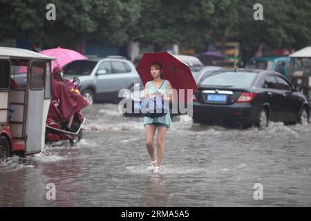 (140618) -- QUANZHOU, June 18, 2014 (Xinhua) -- A resident walks on a flooded road in Quanzhou County of Guilin, south China s Guangxi Zhuang Autonomous Region, June 18, 2014. A rainstorm hit seven counties and cities of Guilin on Wednesday. (Xinhua/Wang Zichuang) (lfj) CHINA-GUANGXI-GUILIN-WATERLOGGING (CN) PUBLICATIONxNOTxINxCHN   Quanzhou June 18 2014 XINHUA a Resident Walks ON a flooded Road in Quanzhou County of Guilin South China S Guangxi Zhuang Autonomous Region June 18 2014 a Rainstorm Hit Seven Counties and CITIES of Guilin ON Wednesday XINHUA Wang Zichuang  China Guangxi Guilin wate Stock Photo