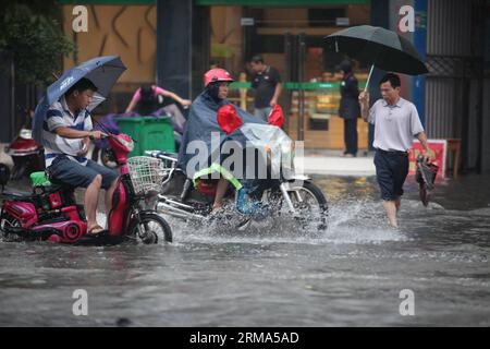 (140618) -- QUANZHOU, June 18, 2014 (Xinhua) -- Residents ride motorcycles on a flooded road in Quanzhou County of Guilin City, south China s Guangxi Zhuang Autonomous Region, June 18, 2014. A rainstorm hit seven counties and cities of Guilin on Wednesday. (Xinhua/Wang Zichuang) (lfj) CHINA-GUANGXI-GUILIN-WATERLOGGING (CN) PUBLICATIONxNOTxINxCHN   Quanzhou June 18 2014 XINHUA Residents Ride Motorcycles ON a flooded Road in Quanzhou County of Guilin City South China S Guangxi Zhuang Autonomous Region June 18 2014 a Rainstorm Hit Seven Counties and CITIES of Guilin ON Wednesday XINHUA Wang Zichu Stock Photo