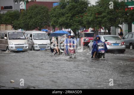 (140618) -- QUANZHOU, June 18, 2014 (Xinhua) -- Residents ride motorcycles on a flooded road in Quanzhou County of Guilin, south China s Guangxi Zhuang Autonomous Region, June 18, 2014. A rainstorm hit seven counties and cities of Guilin on Wednesday. (Xinhua/Wang Zichuang) (lfj) CHINA-GUANGXI-GUILIN-WATERLOGGING (CN) PUBLICATIONxNOTxINxCHN   Quanzhou June 18 2014 XINHUA Residents Ride Motorcycles ON a flooded Road in Quanzhou County of Guilin South China S Guangxi Zhuang Autonomous Region June 18 2014 a Rainstorm Hit Seven Counties and CITIES of Guilin ON Wednesday XINHUA Wang Zichuang  China Stock Photo