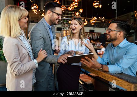 Multiracial business people, friends having fun, working and laughing drinking coffee in coffeehouse Stock Photo