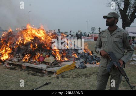 (140626) -- LAHORE, June 26, 2014 (Xinhua) -- A Pakistani paramilitary soldier stands guard beside a burning pile of drugs in eastern Pakistan s Lahore June 26, 2014, on International Day against Drug Abuse and Illicit Trafficking. (Xinhua/Sajjad) PAKISTAN-LAHORE-DRUGS-BURNING PUBLICATIONxNOTxINxCHN   Lahore June 26 2014 XINHUA a Pakistani paramilitary Soldier stands Guard Beside a Burning Pile of Drugs in Eastern Pakistan S Lahore June 26 2014 ON International Day against Drug abuse and Illicit Trafficking XINHUA Sajjad Pakistan Lahore Drugs Burning PUBLICATIONxNOTxINxCHN Stock Photo