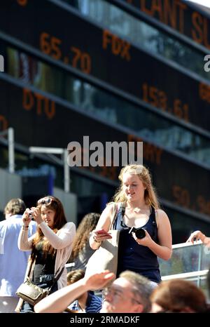 (140703) -- NEW YORK, July 3, 2014 (Xinhua) -- Tourists gather in front of the screens which shows the Dow Jones Industrial Index at the New York s Time Square in New York, the United States on July 3, 2014. U.S. stocks closed at record highs Thursday to end a holiday shortened week, with the Dow Jones Industrial Average settling above 17,000 points for the first time, boosted by stronger-than-expected U.S. nonfarm payroll report. (Xinhua/Wang Lei) U.S.-NEW YORK-DOW JONES-HIGH PUBLICATIONxNOTxINxCHN   New York July 3 2014 XINHUA tourists gather in Front of The Screens Which Shows The Dow Jones Stock Photo