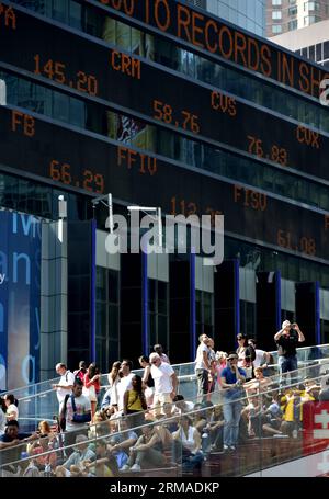 (140703) -- NEW YORK, July 3, 2014 (Xinhua) -- Tourists gather in front of the screens which shows the Dow Jones Industrial Index at the New York s Time Square in New York, the United States on July 3, 2014. U.S. stocks closed at record highs Thursday to end a holiday shortened week, with the Dow Jones Industrial Average settling above 17,000 points for the first time, boosted by stronger-than-expected U.S. nonfarm payroll report. (Xinhua/Wang Lei) U.S.-NEW YORK-DOW JONES-HIGH PUBLICATIONxNOTxINxCHN   New York July 3 2014 XINHUA tourists gather in Front of The Screens Which Shows The Dow Jones Stock Photo