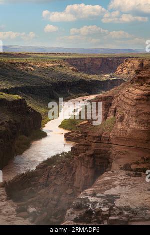 From the top of Grand Falls the Little Colorado River flows toward the Colorado River carrying the desert monsoon rains across the Navajo Nation. Stock Photo