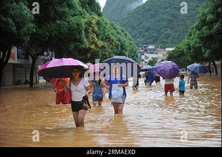 (140705) -- MASHAN, July 5, 2014 (Xinhua) -- People leave for safe places in Mashan County, south China s Guangxi Zhuang Autonomous Region, July 5, 2014. Torrential rain hit Guangxi since July 4, where the precipitation exceeded 100 mm in 21 counties. (Xinhua/Zhang Ailin) (hdt) CHINA-GUANGXI-RAIN (CN) PUBLICATIONxNOTxINxCHN   Mashan July 5 2014 XINHUA Celebrities Leave for Safe Places in Mashan County South China S Guangxi Zhuang Autonomous Region July 5 2014 torrential Rain Hit Guangxi Since July 4 Where The precipitation exceeded 100 MM in 21 Counties XINHUA Zhang Ailin HDT China Guangxi Rai Stock Photo