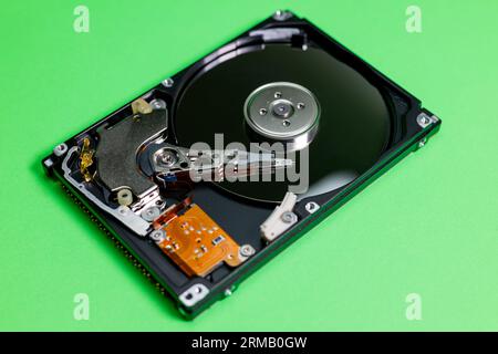 open hard disk drive isolated, green background Stock Photo