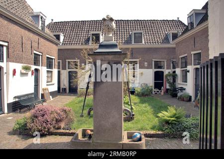 LEIDEN, HOLLAND-MAY 03 2008:The Brouchoven Hofje in Leiden is one of the old beguinages in Europe with an old fashioned water pump Stock Photo