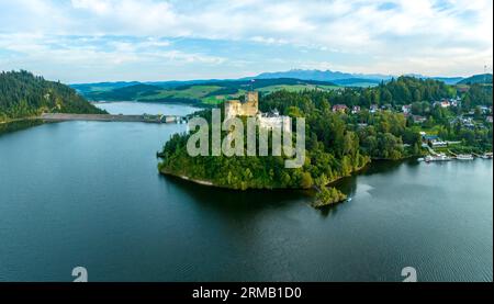 Poland. Medieval castle in Niedzica in sunset light. Artificial Czorsztyn lake, two dams on Dunajec river, hydro power station, small tourist harbor. Stock Photo