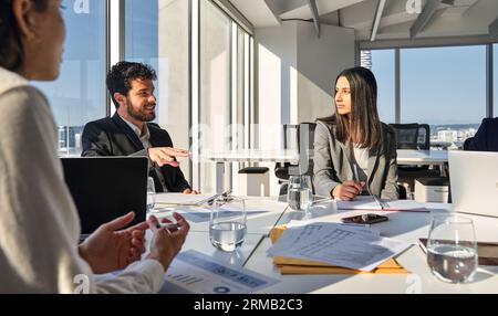Busy international executives team young people working at board room. Stock Photo