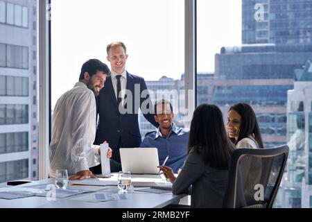 Professional happy diverse team business people talking at office meeting. Stock Photo