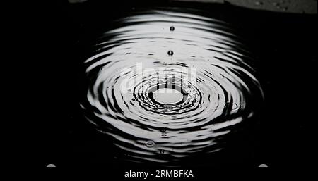 Drop of Water falling into Water, Full Moon Stock Photo