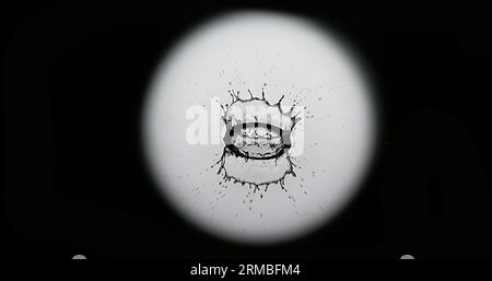 Drop of Water falling into Water, Full Moon Stock Photo