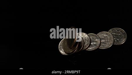 Quarter Dollar Coins Falling, Rolling and Sliding on Black Background ...