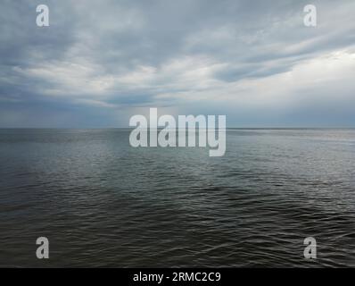 dark sea and sky - calm sea, cloudy sky - sea view, horizontal wallpaper Stock Photo