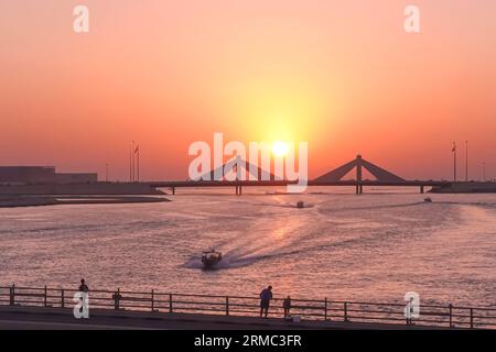 Sunset over the bridge in Bahrain seen from Muharraq district Stock Photo