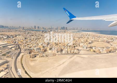 Bahrain  from airplane with FlyDubai wing  - view out of airplane window, aircraft wing FlyDubai airline - aerial view Bahrain an airplane window seat Stock Photo
