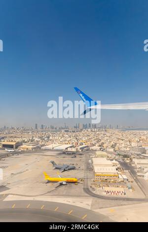 Bahrain  from airplane with FlyDubai wing  - view out of airplane window, aircraft wing FlyDubai airline - aerial view Bahrain an airplane window seat Stock Photo
